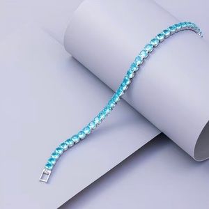 Beautiful Round Blue Topaz Bracelet In White Gold